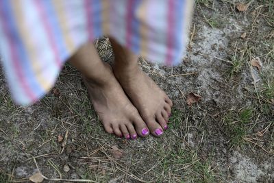 Low section of woman standing on land