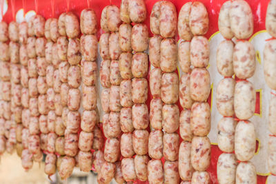 Beef and pork sausages are hung for sale in the market.