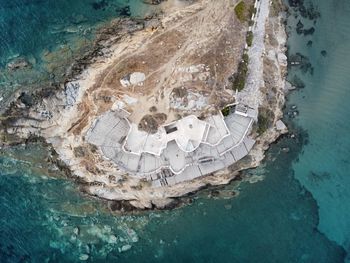 High angle view of sea from drone over abandoned building