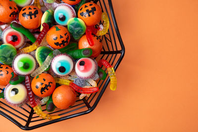 High angle view of multi colored candies in basket