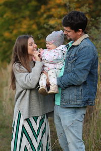 Happy young family walking in nature