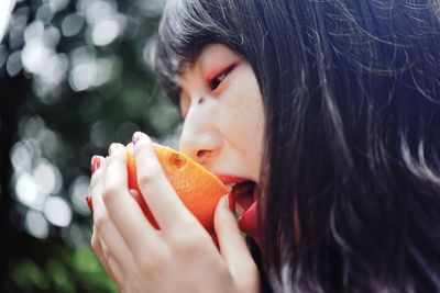 Close-up portrait of a woman eating food