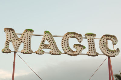 Low angle view of sign against clear sky