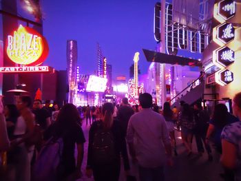 People on illuminated city at night