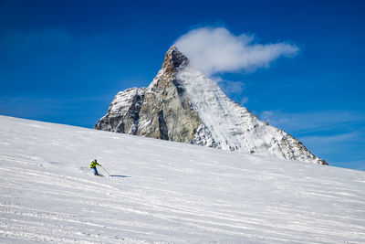 Low angle view of snowcapped mountains against sky