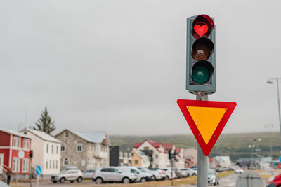 Low angle view of road sign against sky