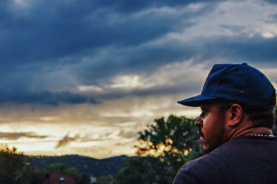 Portrait of man standing against sky during sunset