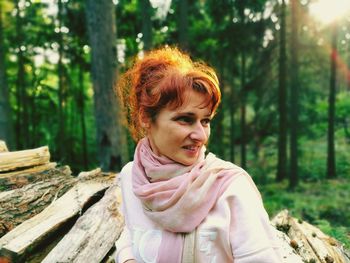 Portrait of smiling young woman in forest