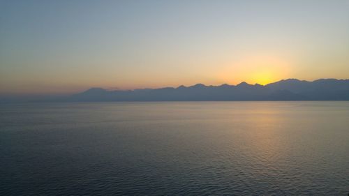 Scenic view of sea against clear sky during sunset