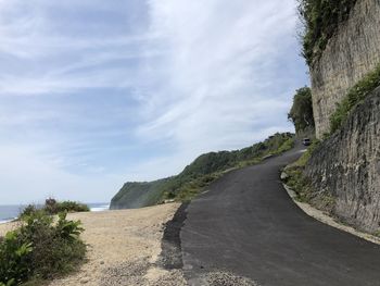 Road amidst trees against sky