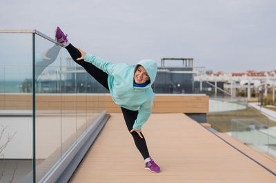 Full length of young man exercising at airport