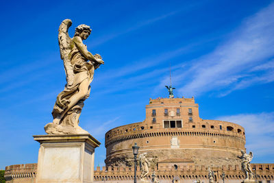 Low angle view of statue against blue sky