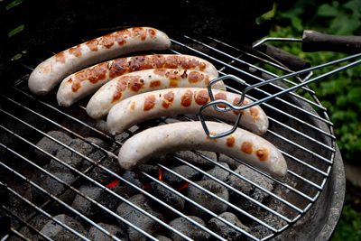 High angle view of sausages on barbecue