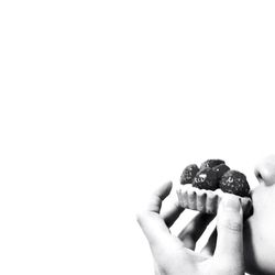 Cropped image of hand holding over white background