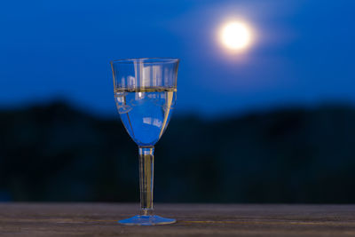 Glas of white wine in the moonlight