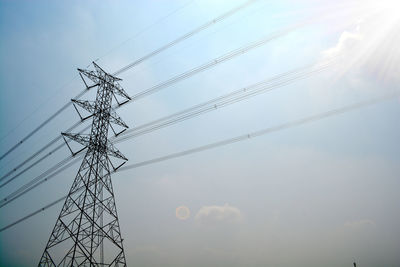 Low angle view of electricity pylon against sky