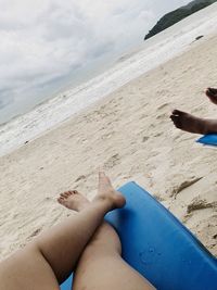 Low section of woman legs on beach