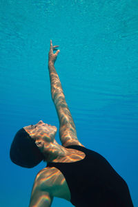 Female model swimming in pool