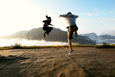 People jumping into the sea of clouds at the ruins of takeda castle