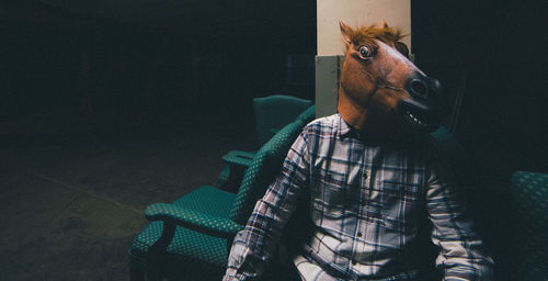 Man wearing mask sitting on seat