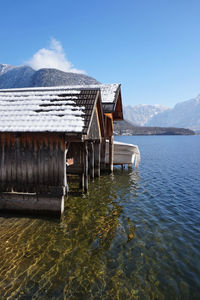 Built structure by lake against sky