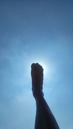 Low angle view of hand against sky