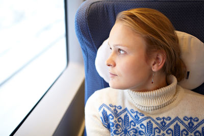 Woman looking through train window