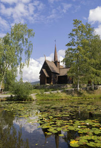 Scenic view of lake by building against sky