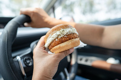 Cropped hand of woman holding food