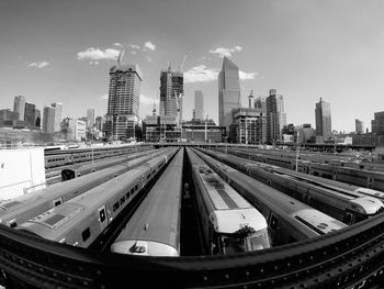 Panoramic view of city with trains against sky