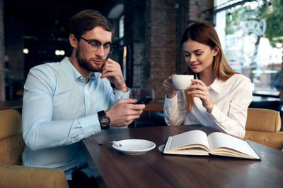 Young couple sitting on table