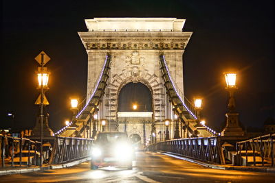 Illuminated bridge at night