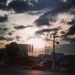 Road against cloudy sky at sunset