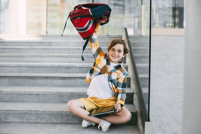 Woman sitting on staircase