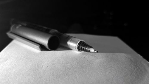 Close-up of pen on table