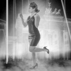 Side view of woman dancing against window