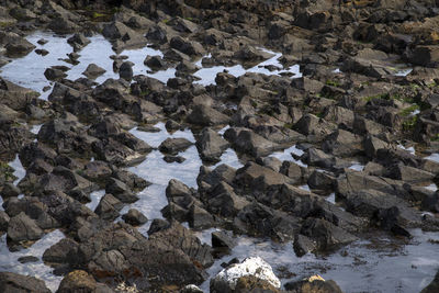 High angle view of stream flowing through rocks