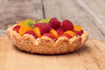 Close-up of fruits on tart at table