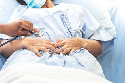 Midsection of couple holding hands