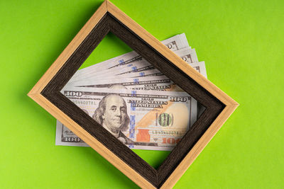 Close-up of information sign against green background