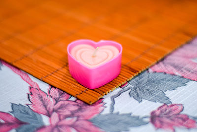 Heart shaped candle on table