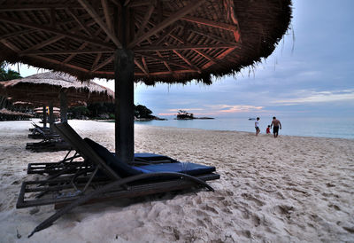 People at beach against sky