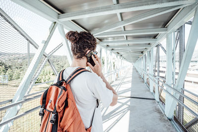 Rear view of man talking on smart phone