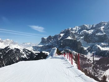 Snow covered mountain against blue sky