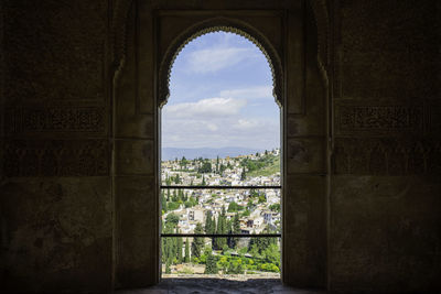 View of albaicín through an ornate doorway - granada, spain