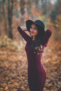 Young woman wearing hat standing on land during autumn
