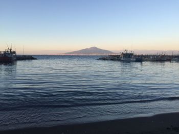 Scenic view of sea against clear sky during sunset