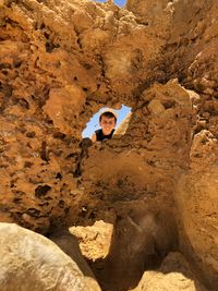 Portrait of young man on rock