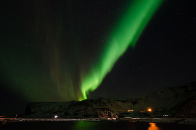 Scenic view of lake against sky at night