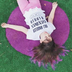 High angle view of girl lying on carpet